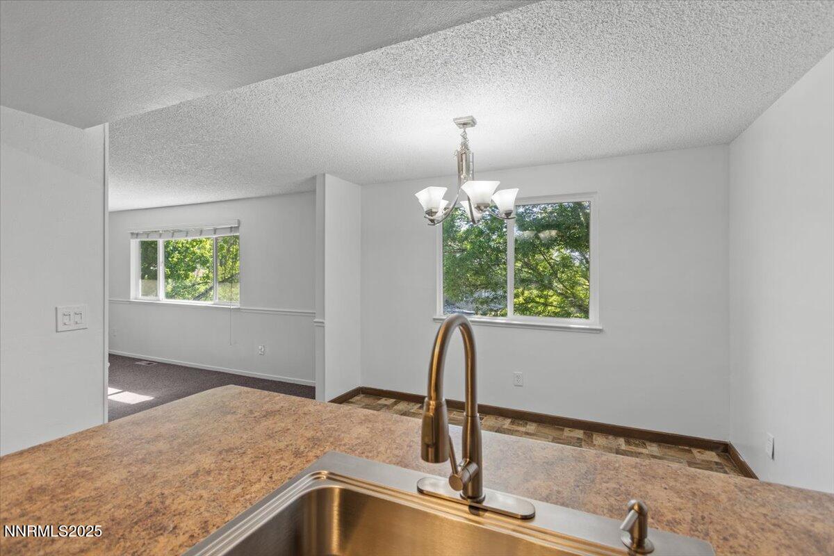 1090 Hartford Court Reno, NV 89503 - Photo 10 of 45 a view of a kitchen with a sink wooden floor and a window