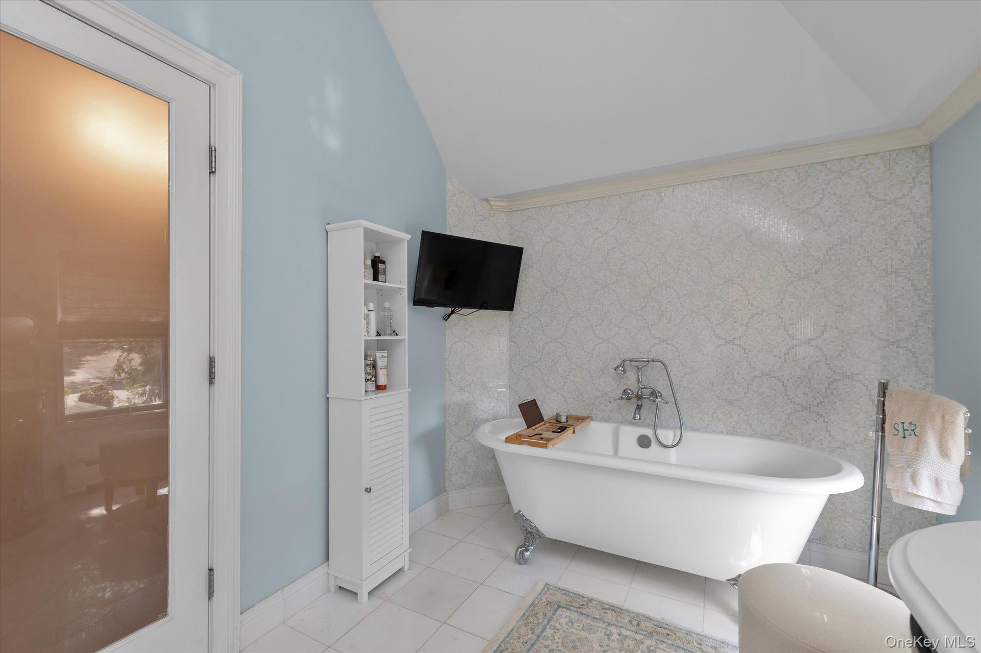 80 Skunks Misery Road Locust Valley, NY 11560 - Photo 19 of 25 a bathroom with a white tub shower and mirror