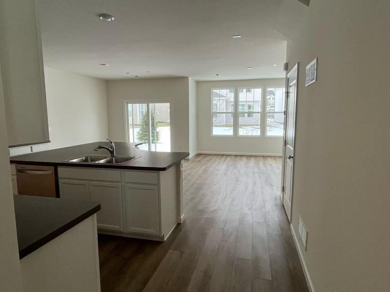 5922 Hawkweed Drive Plainfield, IL 60585 - Photo 4 of 19 a kitchen with granite countertop a stove a sink and wooden floor