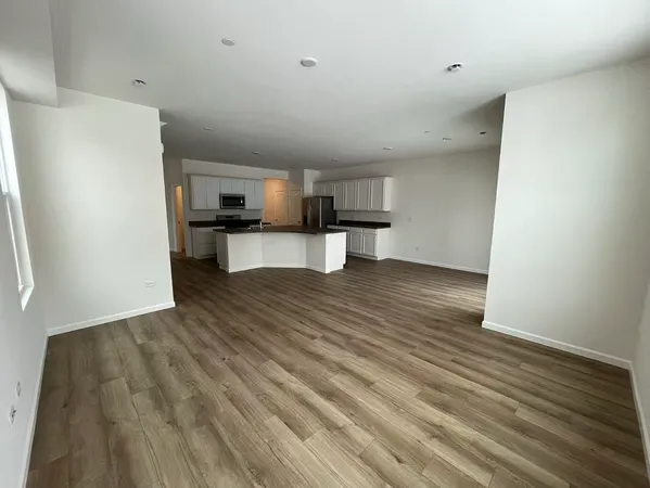 a view of kitchen and wooden floor