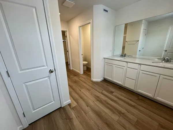 a bathroom with a sink a mirror and a shower