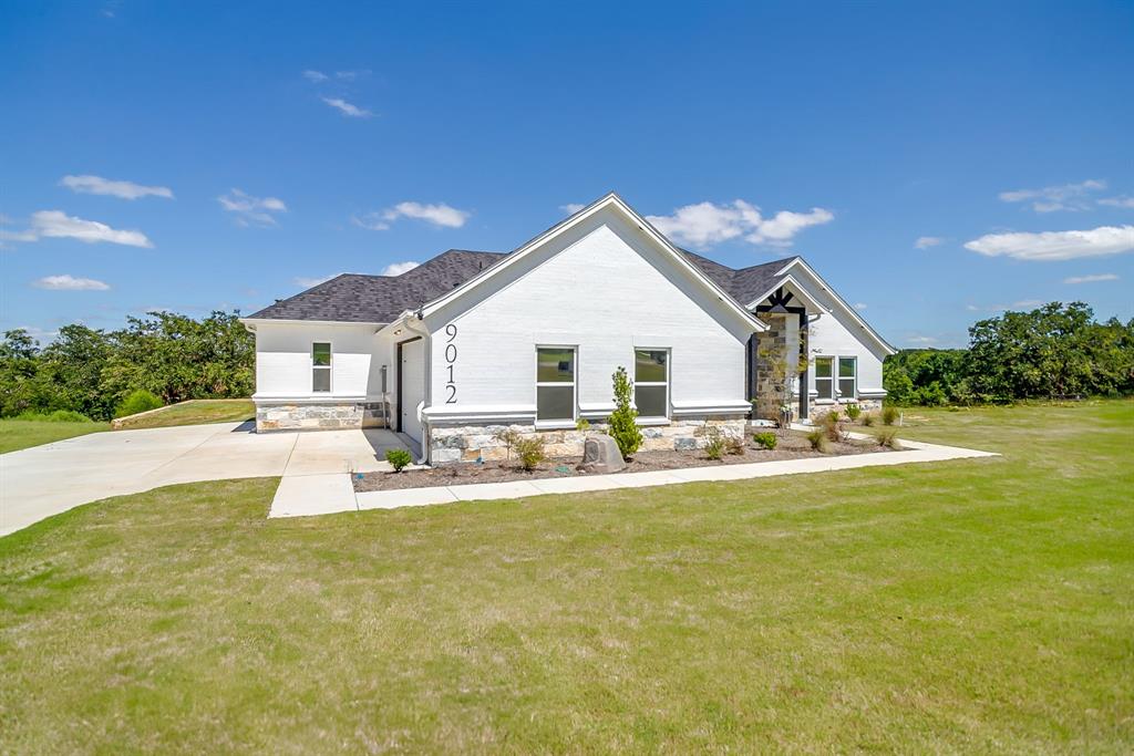 9012 Valley Oak Court Springtown, TX 76082 - Photo 3 of 40 a view of a house with swimming pool and a yard