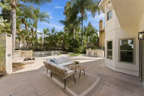 a view of swimming pool with outdoor seating and plants