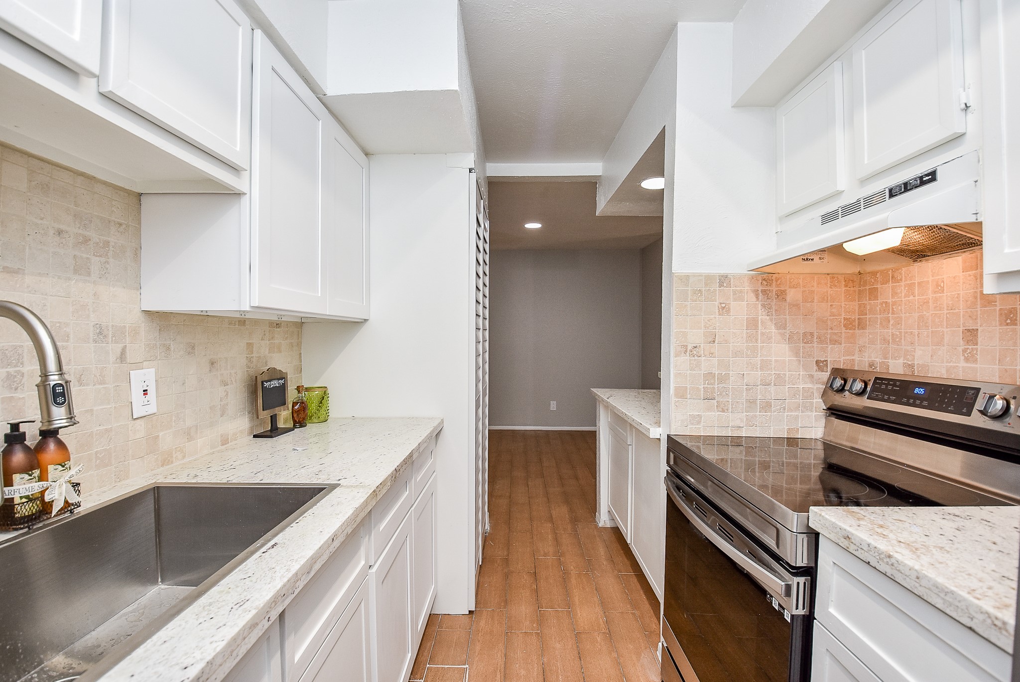 5000 Milwee Street, Unit 74 Houston, TX 77092 - Photo 11 of 35 a kitchen with stainless steel appliances granite countertop a sink and a stove