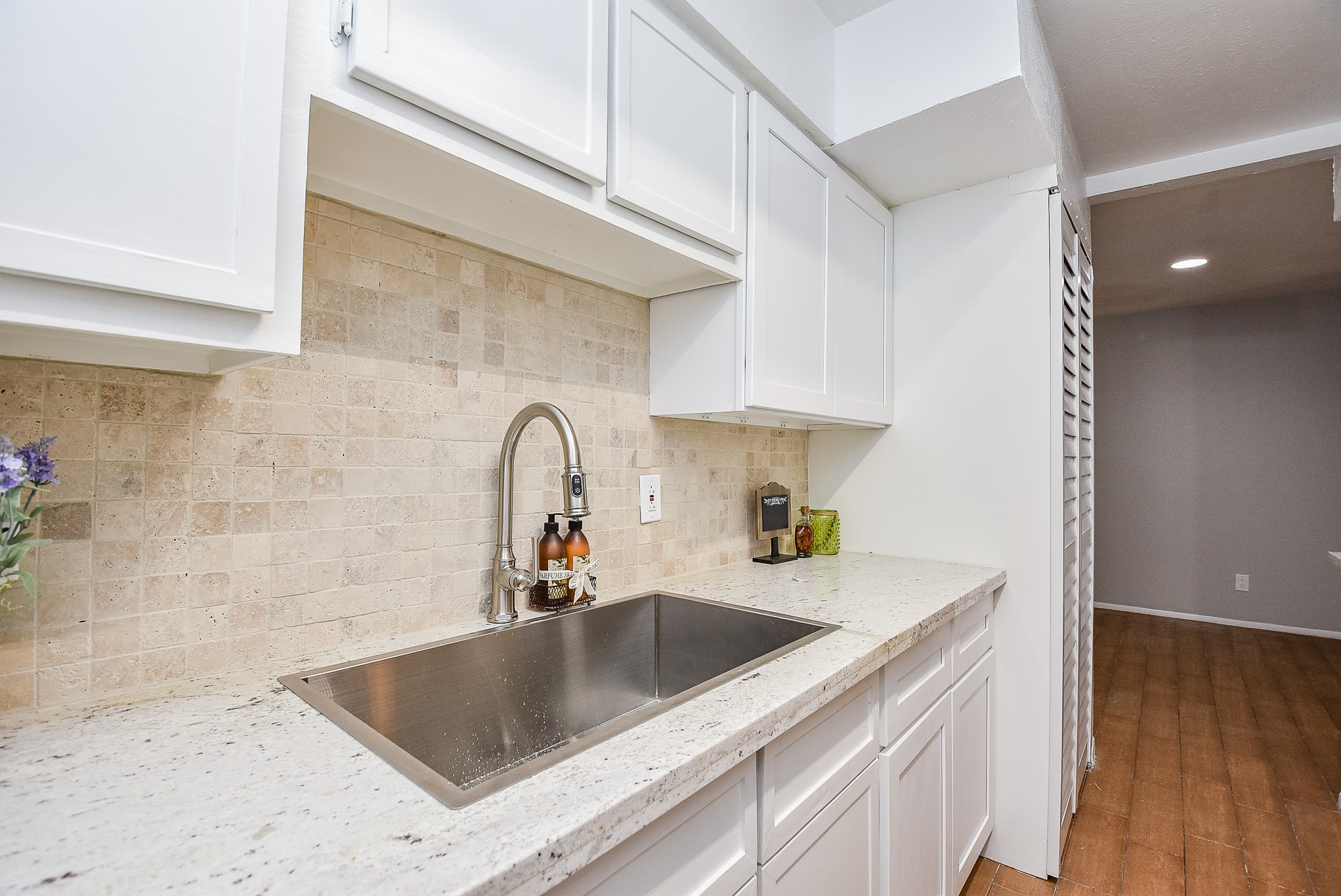 5000 Milwee Street, Unit 74 Houston, TX 77092 - Photo 13 of 35 a kitchen with stainless steel appliances granite countertop a sink a stove and a wooden floors