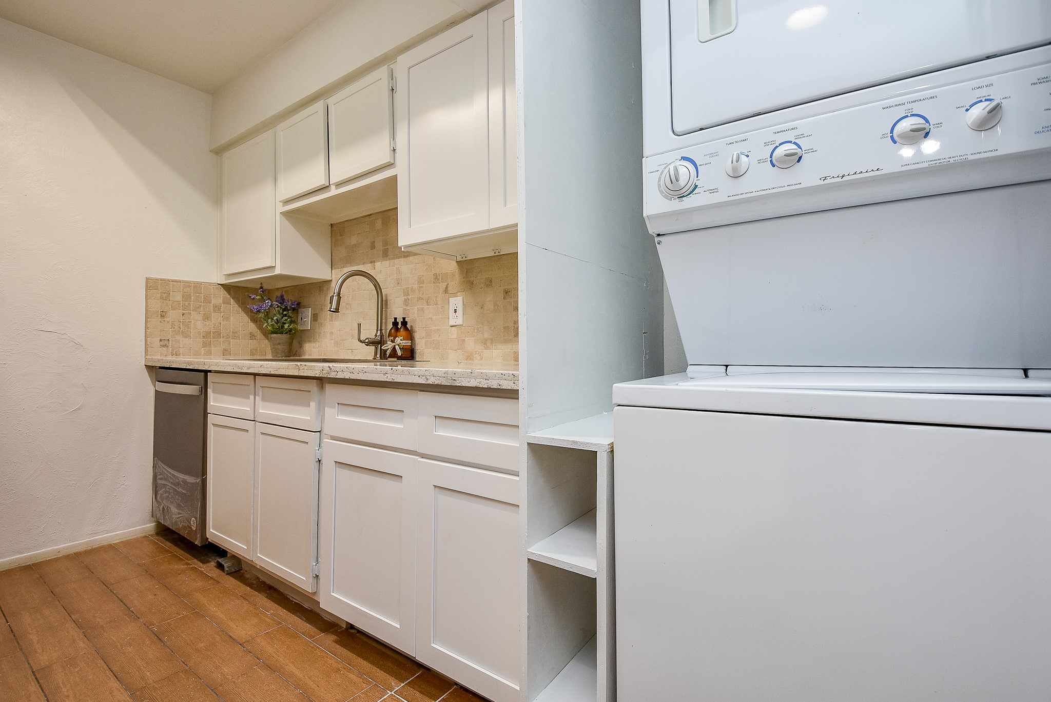5000 Milwee Street, Unit 74 Houston, TX 77092 - Photo 15 of 35 a view of washer and dryer with wooden floor