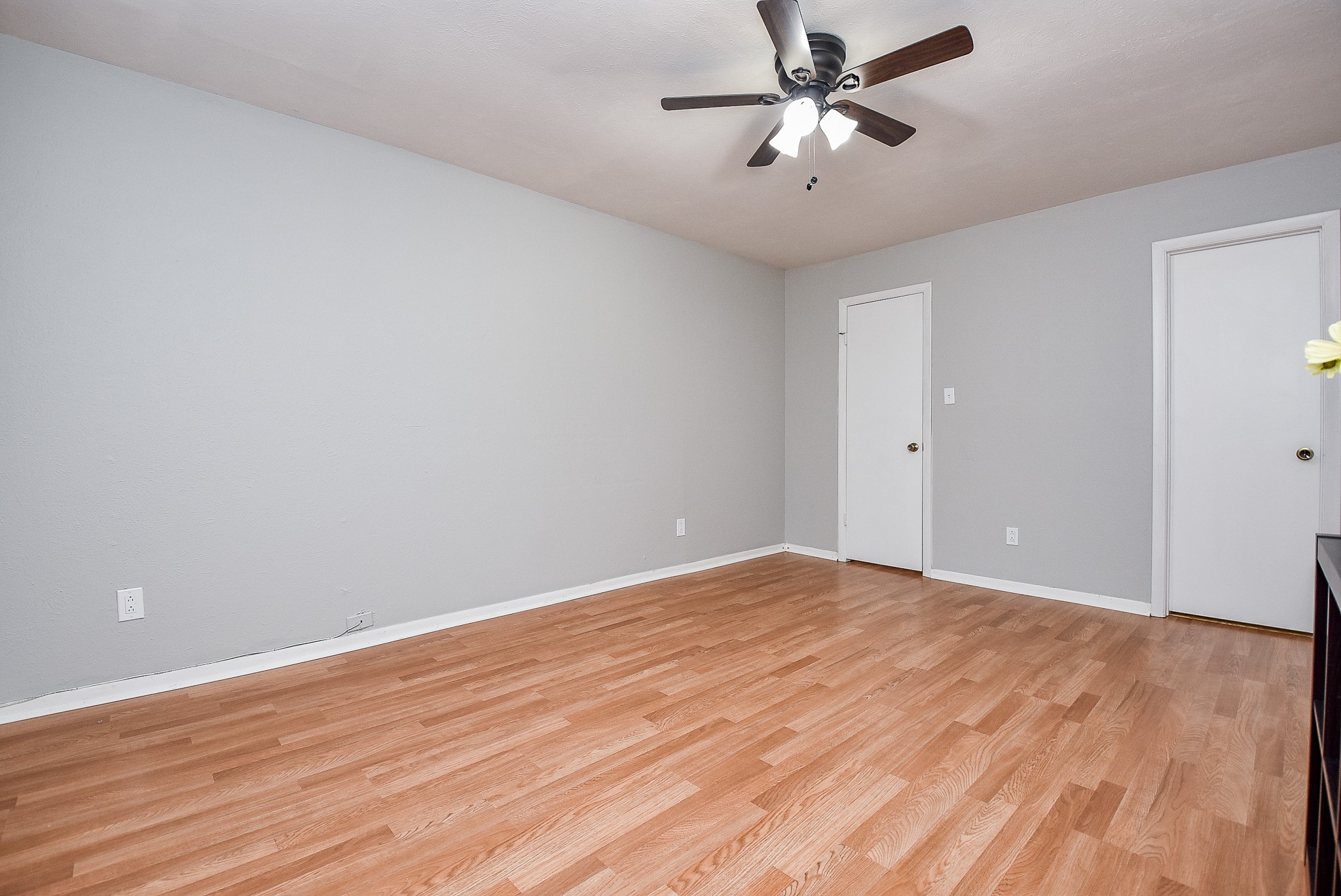 5000 Milwee Street, Unit 74 Houston, TX 77092 - Photo 23 of 35 a view of a big room with wooden floor and a chandelier fan