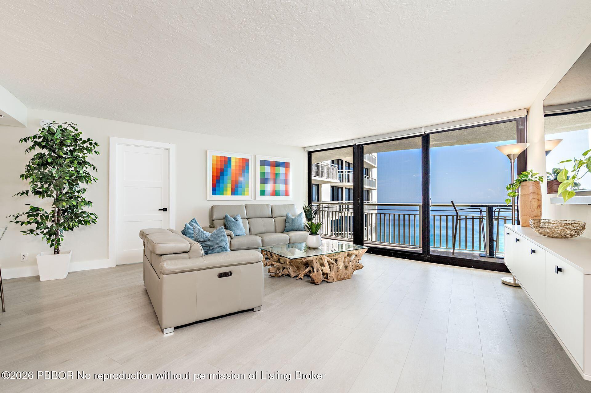 3000 North Ocean Drive, Unit 32E Riviera Beach, FL 33404 - Photo 14 of 36 a living room with furniture stairs and a potted plant