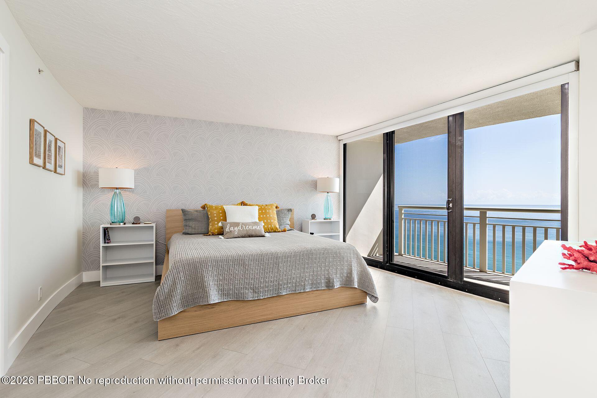 3000 North Ocean Drive, Unit 32E Riviera Beach, FL 33404 - Photo 26 of 36 a bedroom with a bed and a large window