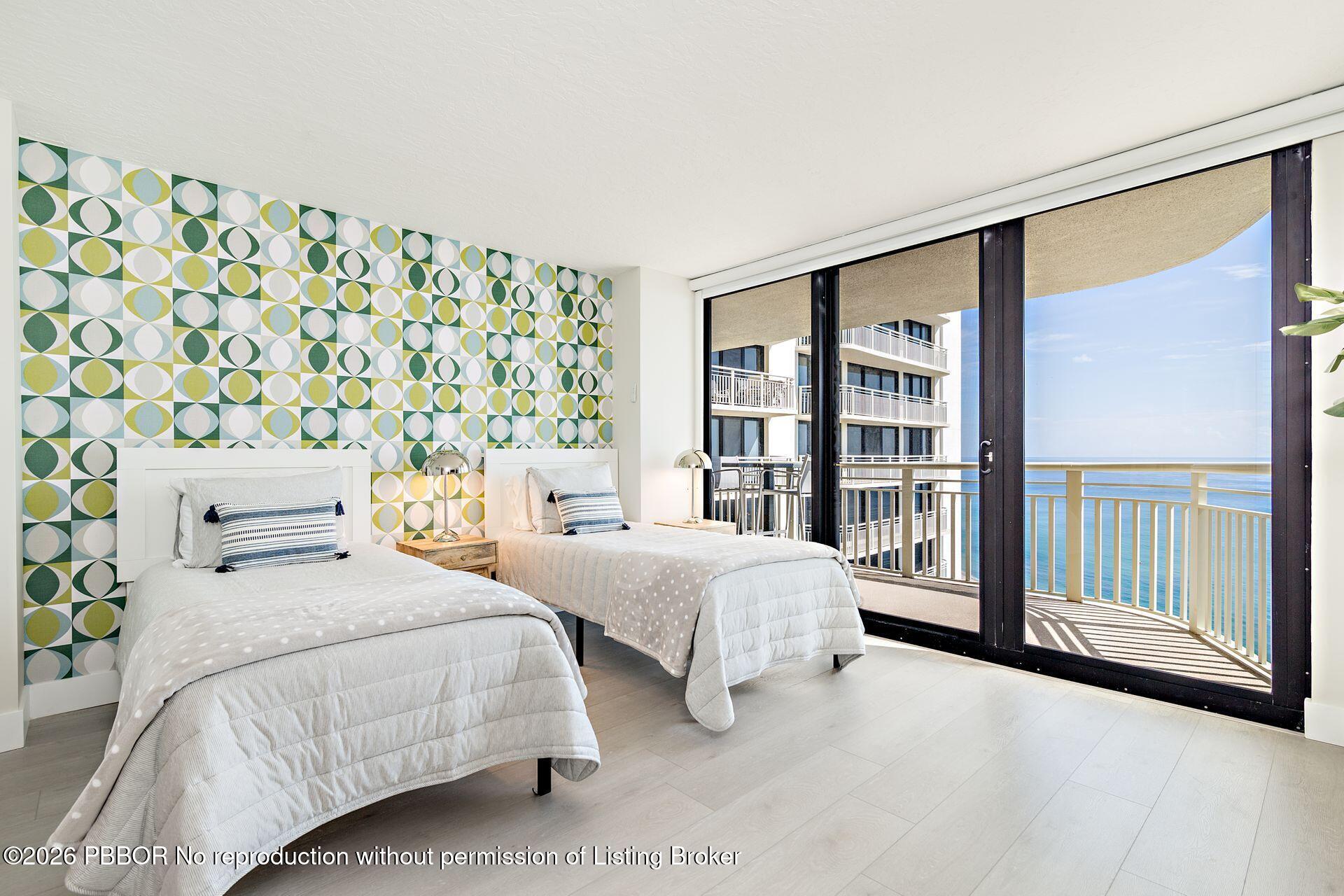3000 North Ocean Drive, Unit 32E Riviera Beach, FL 33404 - Photo 30 of 36 a bedroom with two beds and a large window