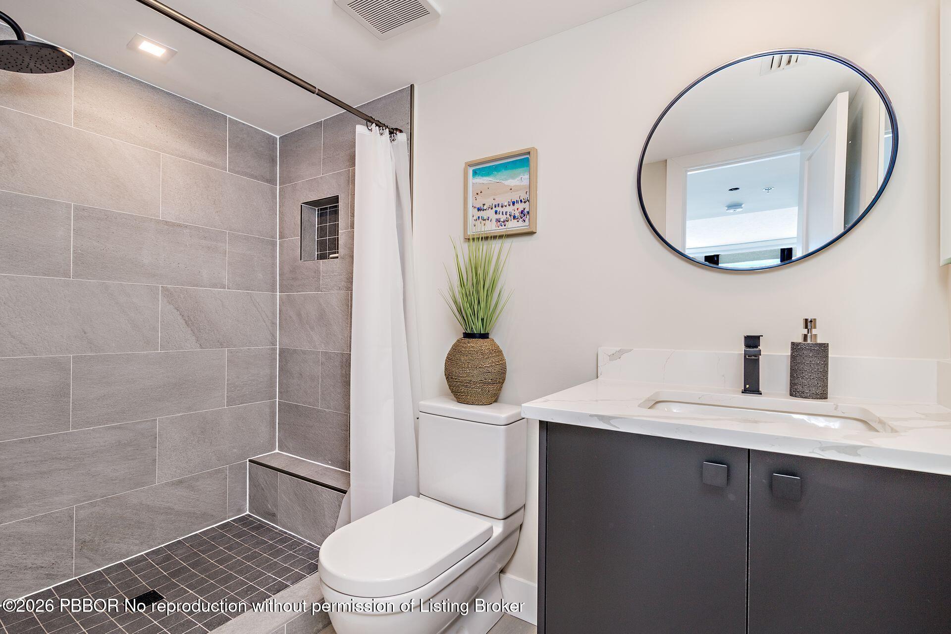 3000 North Ocean Drive, Unit 32E Riviera Beach, FL 33404 - Photo 31 of 36 a bathroom with a toilet a sink and mirror