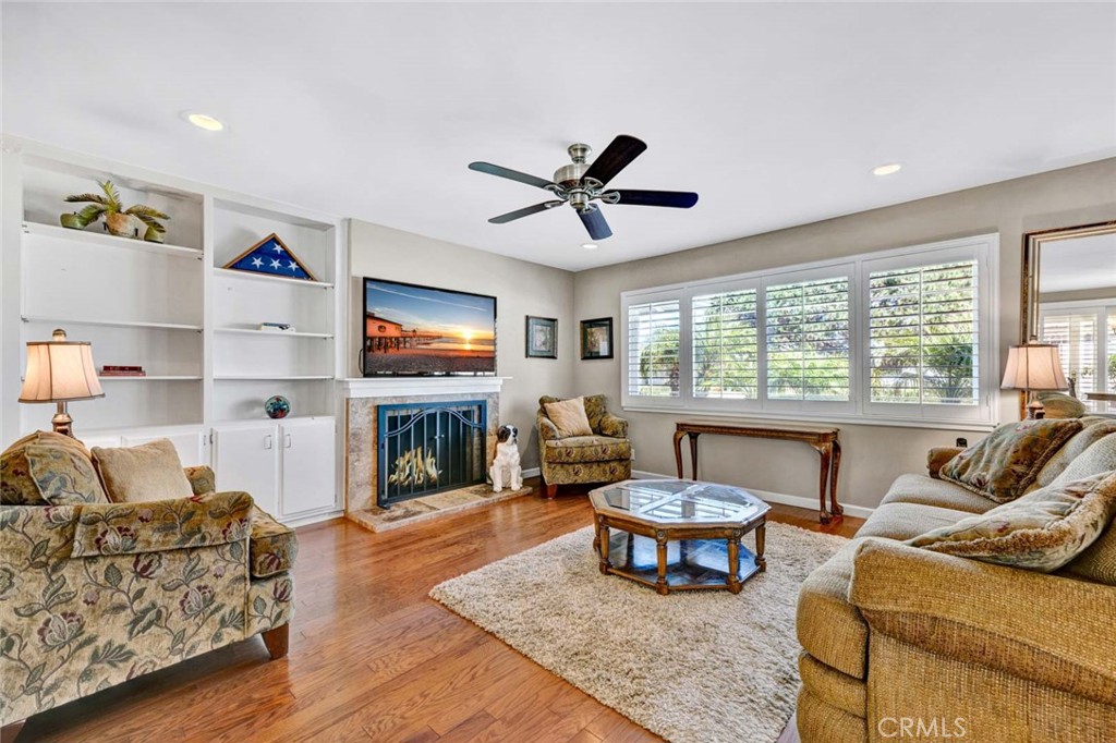 a living room with fireplace furniture and a flat screen tv