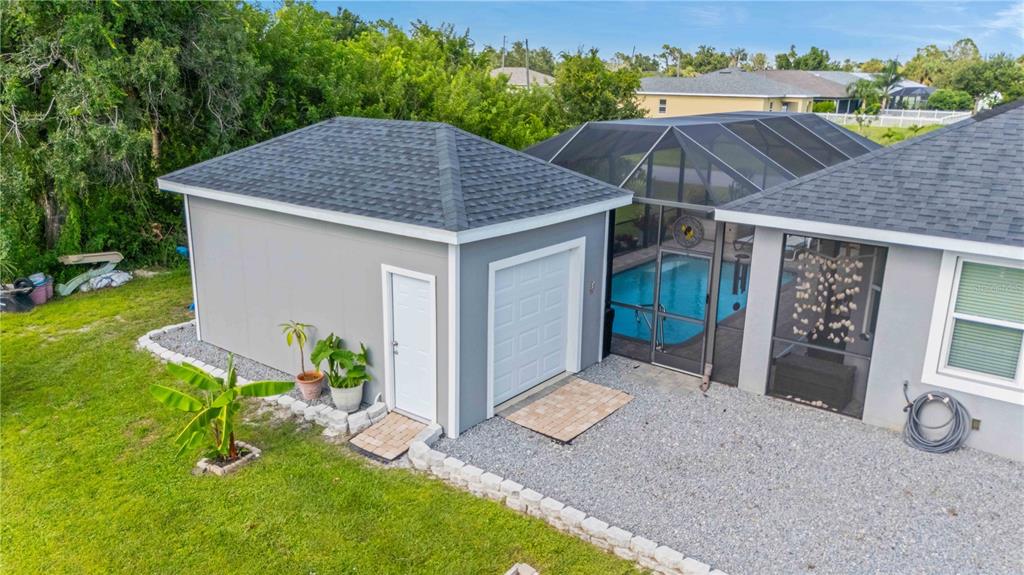114 Venice Road Rotonda West, FL 33947 - Photo 12 of 88 a aerial view of a house with table and chairs under an umbrella