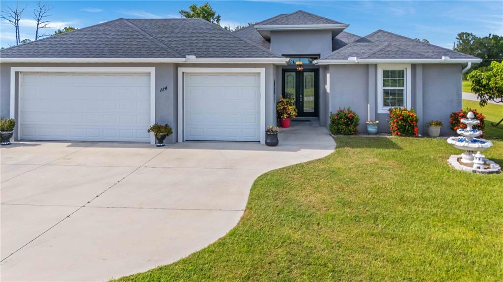 114 Venice Road Rotonda West, FL 33947 - Photo 15 of 88 a front view of a house with garden