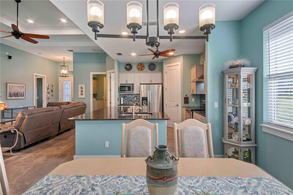 114 Venice Road Rotonda West, FL 33947 - Photo 21 of 88 a living room with furniture a large window and a table