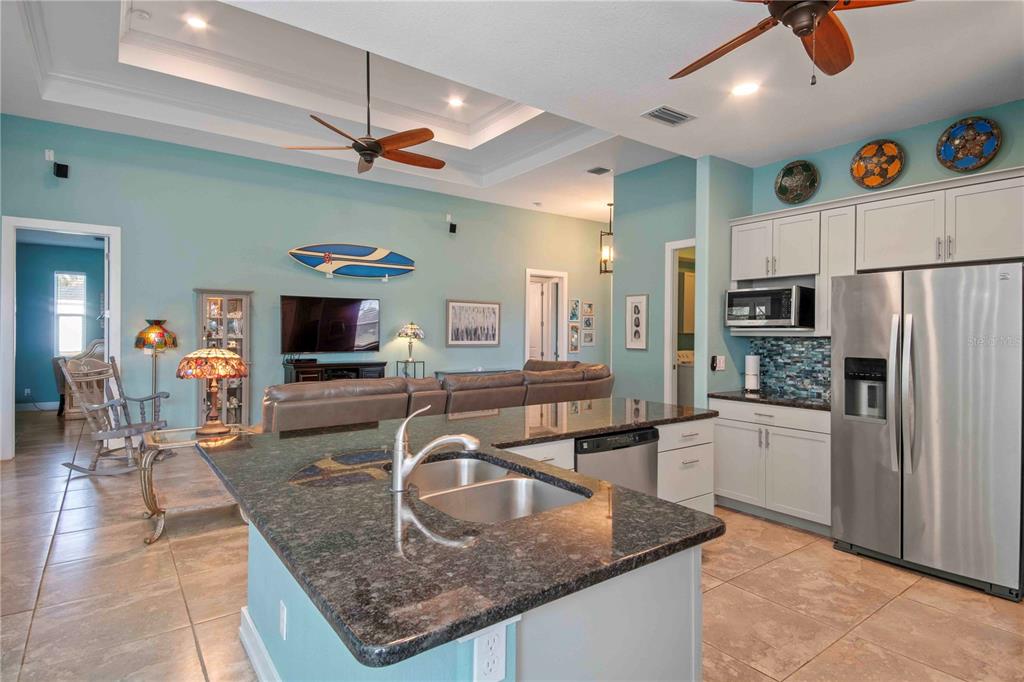 114 Venice Road Rotonda West, FL 33947 - Photo 22 of 88 a kitchen with stainless steel appliances granite countertop a sink refrigerator and cabinets