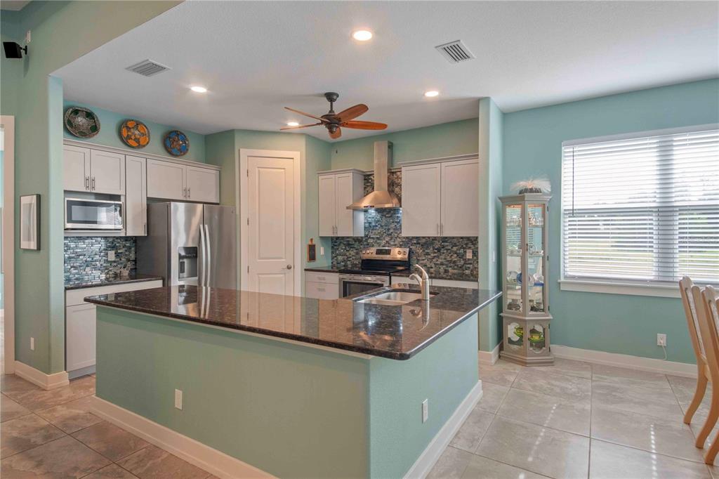 114 Venice Road Rotonda West, FL 33947 - Photo 24 of 88 a kitchen with stainless steel appliances granite countertop a refrigerator and a stove