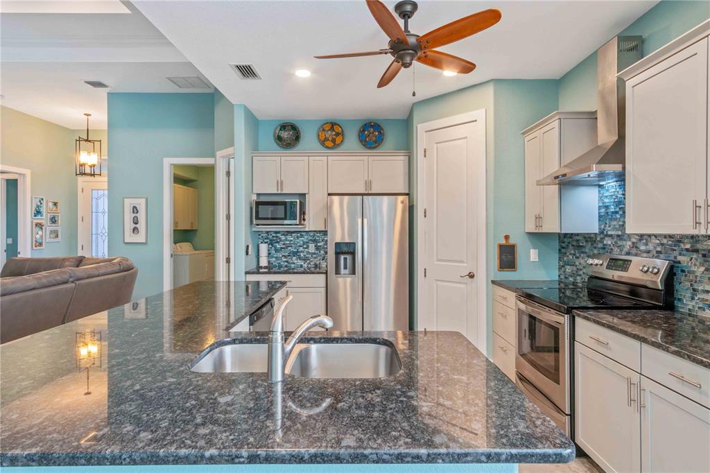 114 Venice Road Rotonda West, FL 33947 - Photo 30 of 88 a kitchen with stainless steel appliances granite countertop a refrigerator a stove and a sink