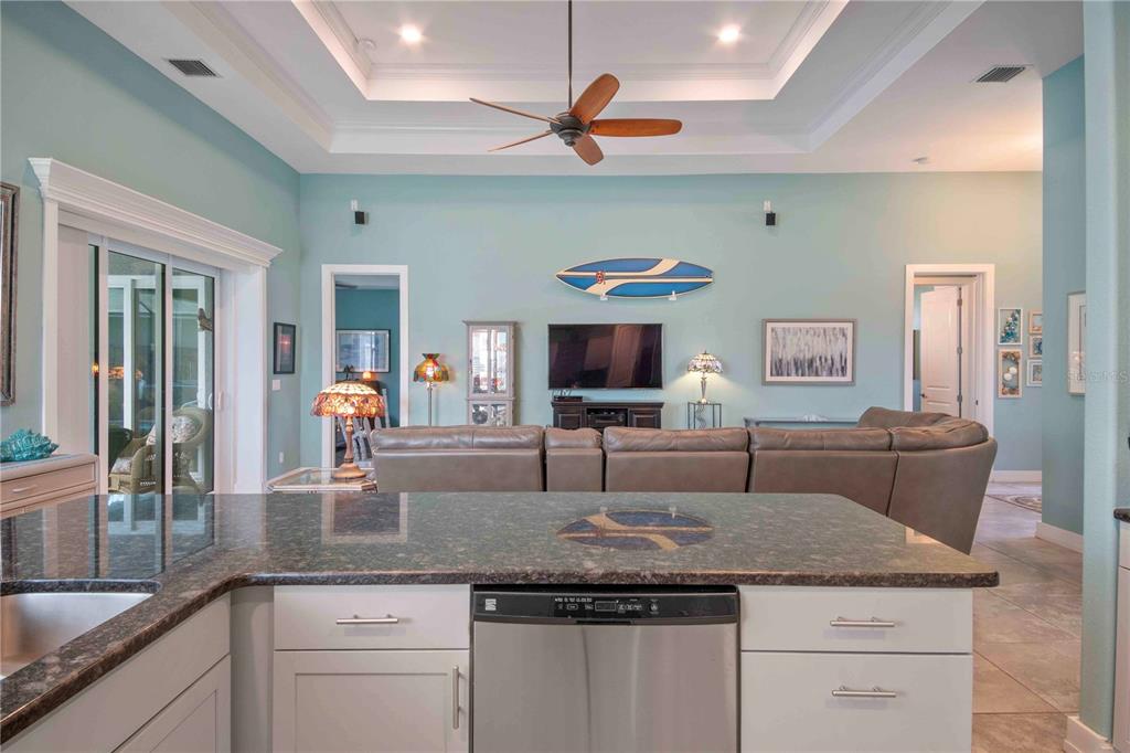 114 Venice Road Rotonda West, FL 33947 - Photo 32 of 88 a kitchen with granite countertop a sink a counter top space and living room view