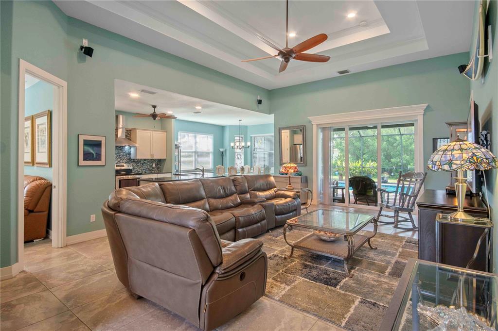 114 Venice Road Rotonda West, FL 33947 - Photo 47 of 88 a living room with furniture a flat screen tv and a large window