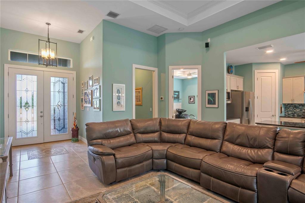 114 Venice Road Rotonda West, FL 33947 - Photo 49 of 88 a living room with furniture and a chandelier