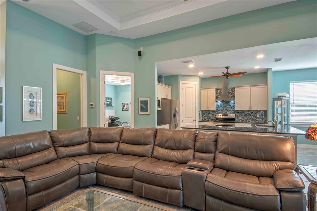 114 Venice Road Rotonda West, FL 33947 - Photo 50 of 88 a living room with furniture kitchen view and a large window