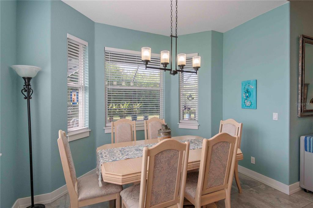 114 Venice Road Rotonda West, FL 33947 - Photo 52 of 88 a dining room with furniture a chandelier and window