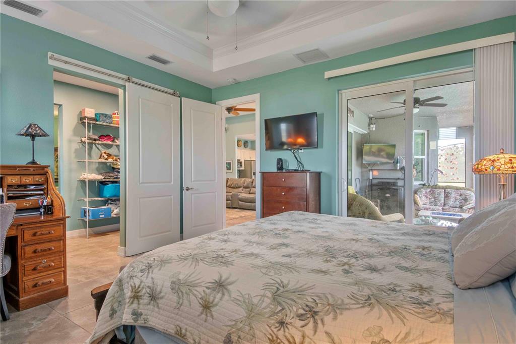 114 Venice Road Rotonda West, FL 33947 - Photo 56 of 88 a bedroom with a bed and a flat tv screen