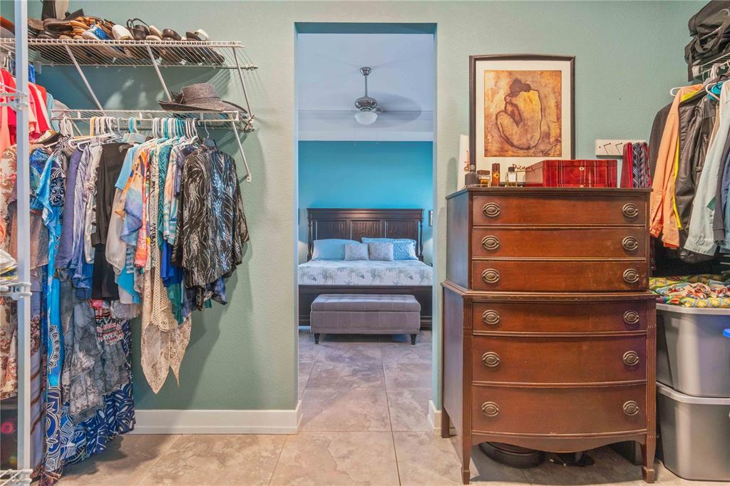 114 Venice Road Rotonda West, FL 33947 - Photo 62 of 88 a view of walk in closet with clothes and shoes