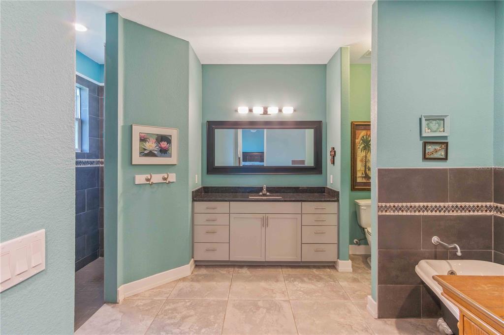 114 Venice Road Rotonda West, FL 33947 - Photo 64 of 88 a bathroom with a sink a vanity and a mirror