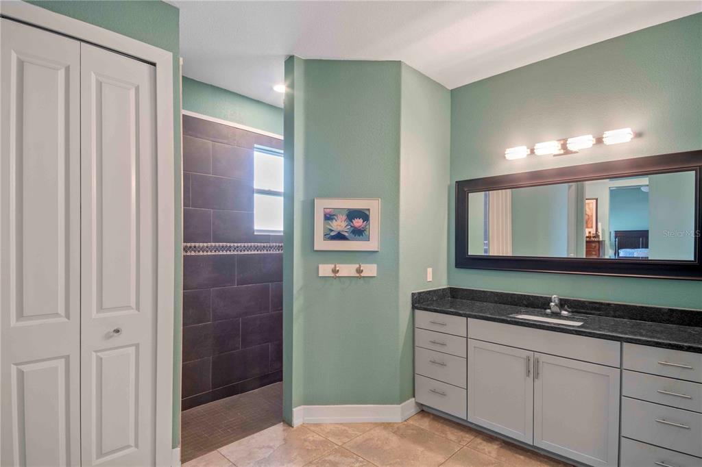 114 Venice Road Rotonda West, FL 33947 - Photo 69 of 88 a bathroom with a granite countertop sink and a mirror