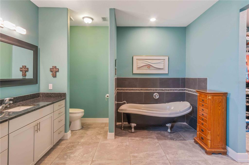 114 Venice Road Rotonda West, FL 33947 - Photo 74 of 88 a bathroom with a granite countertop toilet and a sink