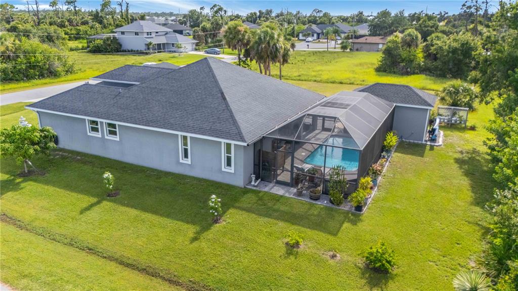114 Venice Road Rotonda West, FL 33947 - Photo 8 of 88 an aerial view of a house with swimming pool big yard and large trees