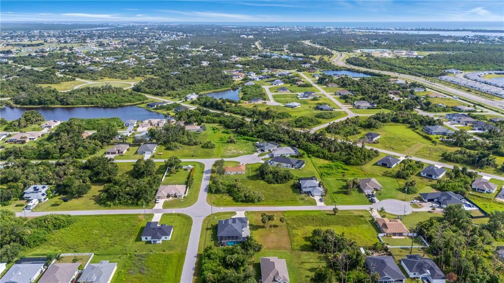 114 Venice Road Rotonda West, FL 33947 - Photo 86 of 88 an aerial view of residential houses with outdoor space and trees
