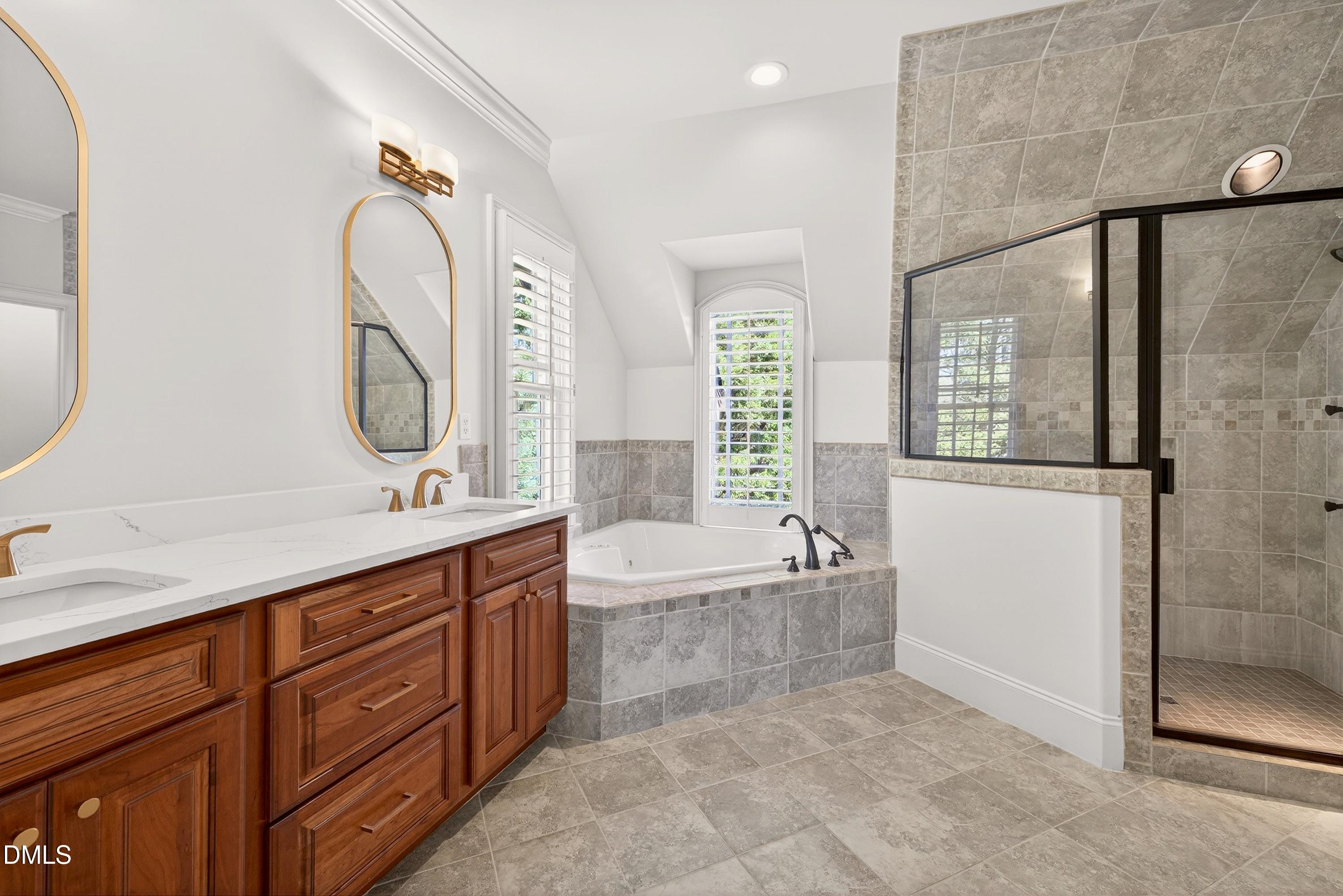 6701 Foxfire Place Raleigh, NC 27615 - Photo 38 of 67 a spacious bathroom with a tub sink and mirror