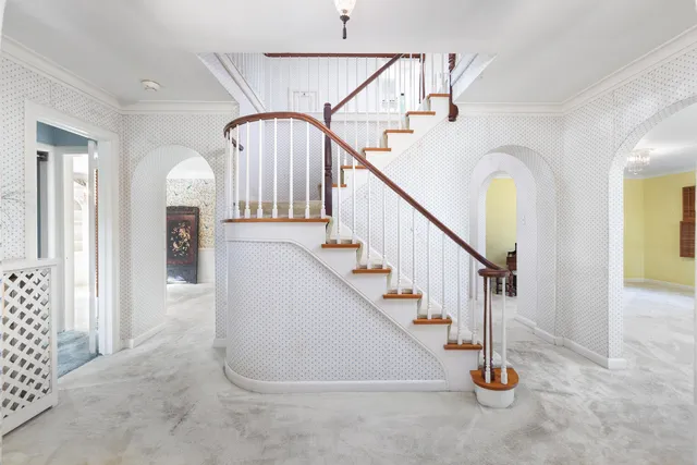 a view of an empty room with a fireplace and a window