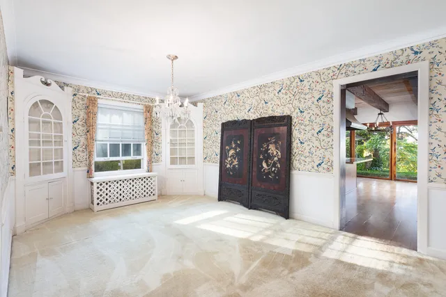 a view of staircase with lots of frames on wall and stairs