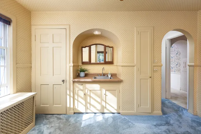 a bathroom with a sink a mirror and a toilet
