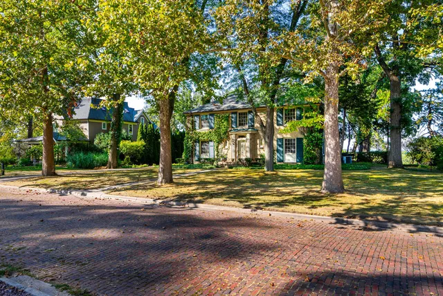 a front view of a house with a yard and a garden