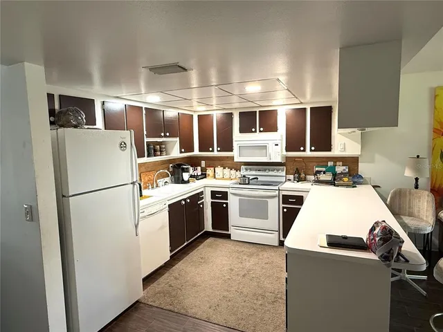 a kitchen with a refrigerator stove and sink