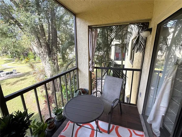 a view of balcony with furniture and wooden floor