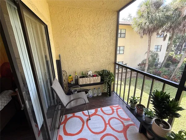 a view of a balcony with chairs