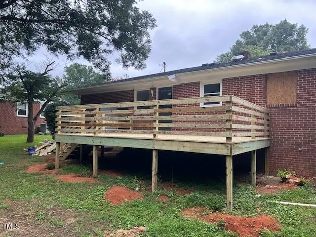 a backyard of a house with table and chairs
