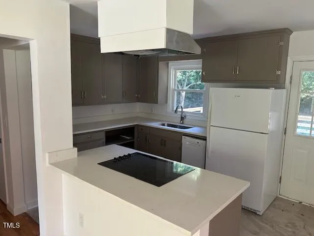 a kitchen with a refrigerator sink and stove