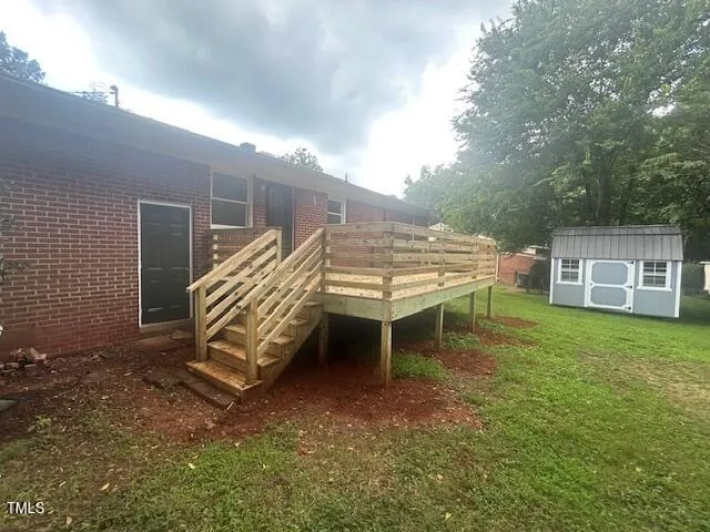 a view of a chairs and table in the backyard