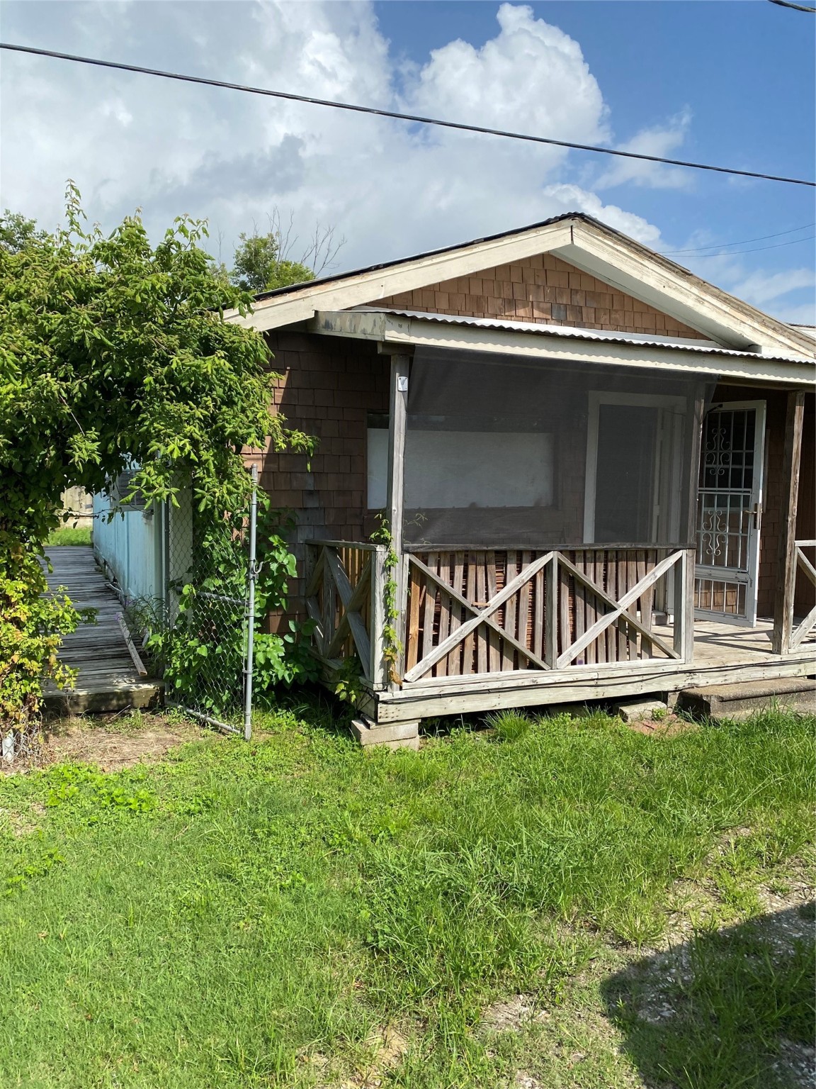 114 2nd Street San Leon, TX 77539 - Photo 4 of 14 a front view of a house with a yard