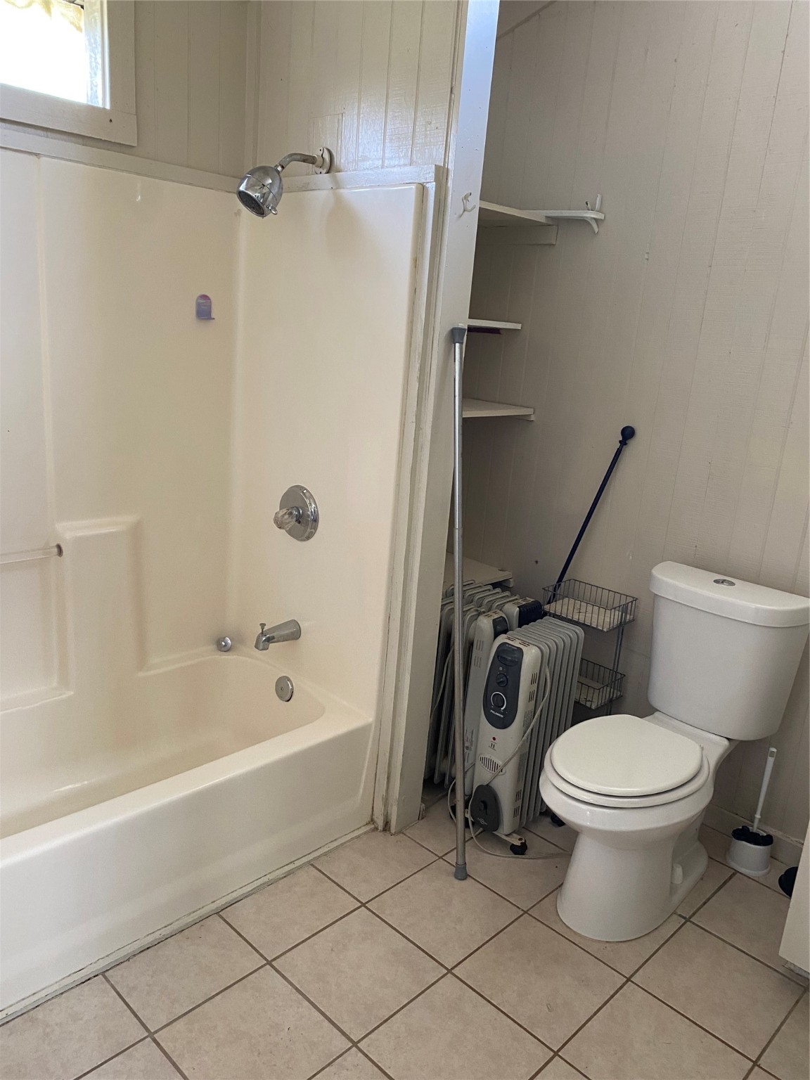 114 2nd Street San Leon, TX 77539 - Photo 7 of 14 a white toilet sitting next to a bath tub and a shower