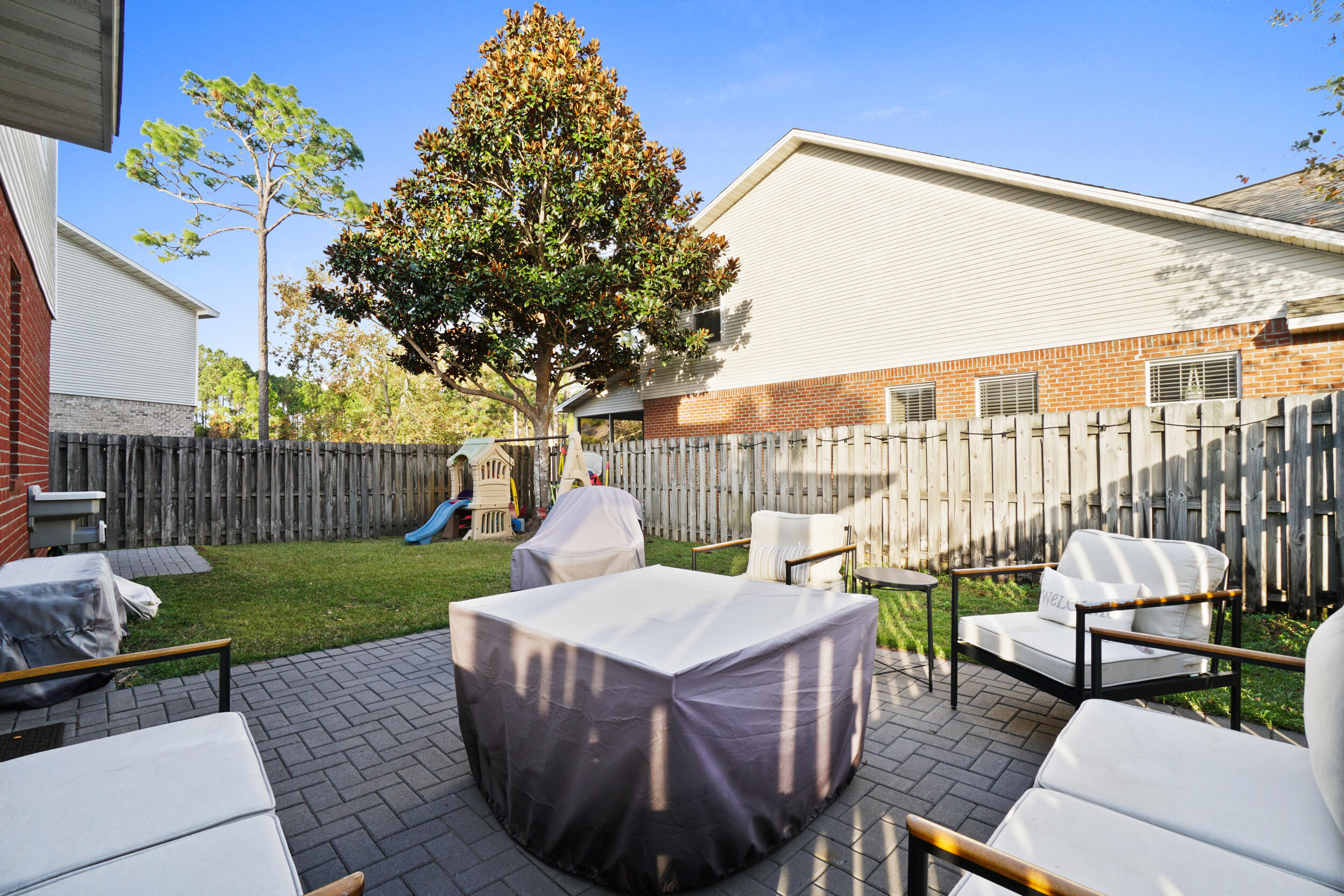31 Corte Lago Santa Rosa Beach, FL 32459 - Photo 24 of 42 a view of a patio with table and chairs and potted plants