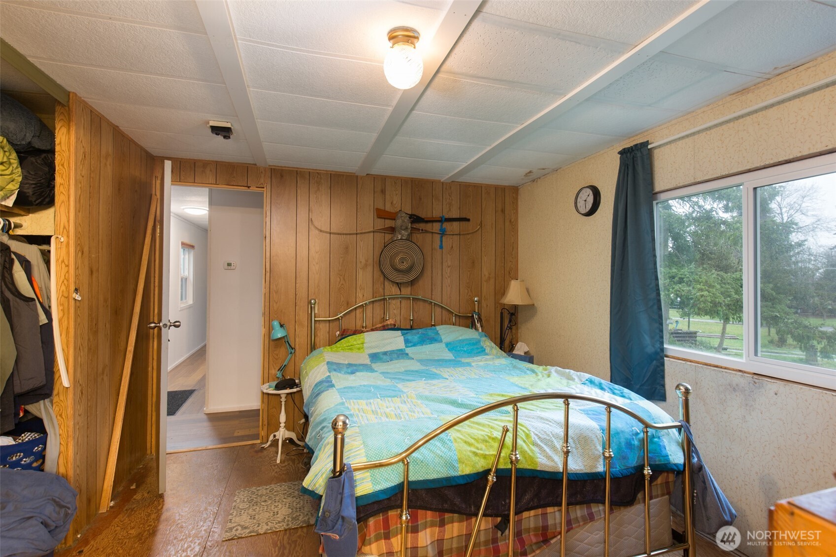 501 McCarver Road Port Angeles, WA 98362 - Photo 11 of 36 a bedroom with a bed a table and potted plant with the view of bathroom