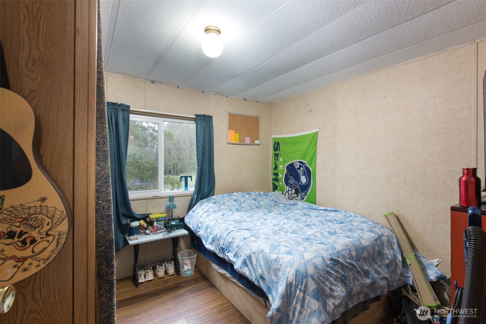501 McCarver Road Port Angeles, WA 98362 - Photo 14 of 36 a bedroom with a bed table and a window